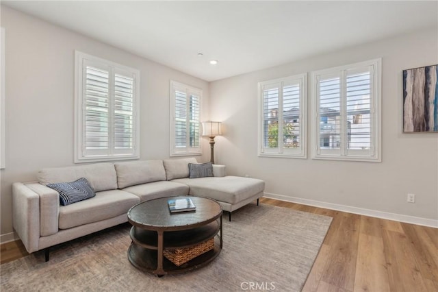 living room with recessed lighting, wood finished floors, and baseboards