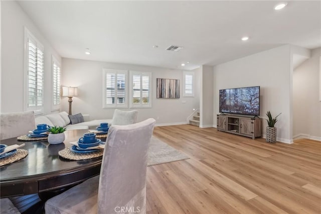 dining space featuring recessed lighting, stairway, visible vents, baseboards, and light wood-style flooring