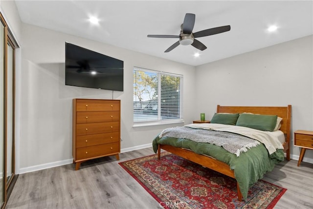 bedroom with wood finished floors, baseboards, a ceiling fan, recessed lighting, and a closet