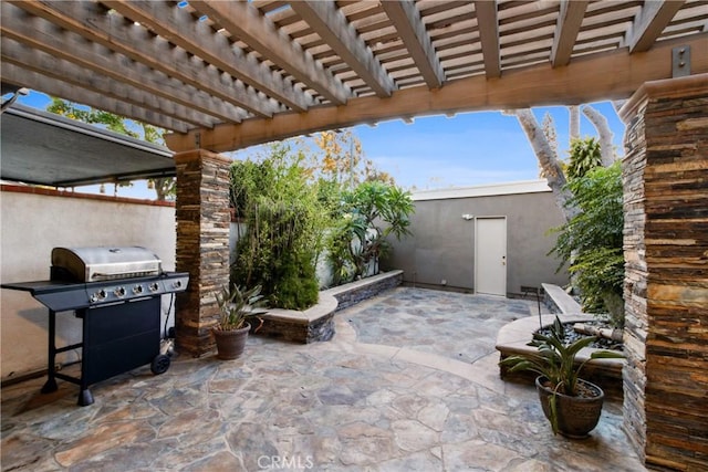 view of patio with a grill, a pergola, and fence