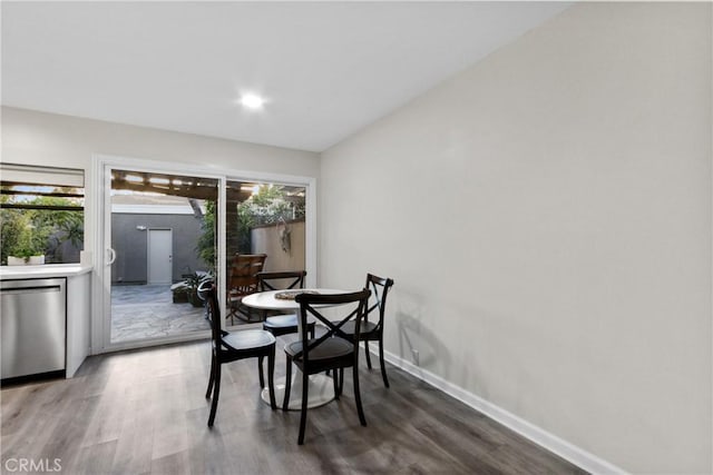 dining space featuring wood finished floors and baseboards