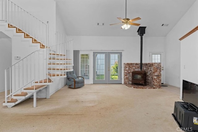 10735 Shasta Blvd, Los Molinos, CA 96055 - living room with high vaulted ceiling, a wood stove, stairs, and carpet