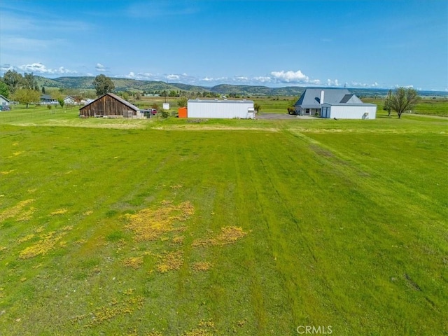 10735 Shasta Blvd, Los Molinos, CA 96055 - view of yard with an outdoor structure, a mountain view, an outbuilding, and a rural view
