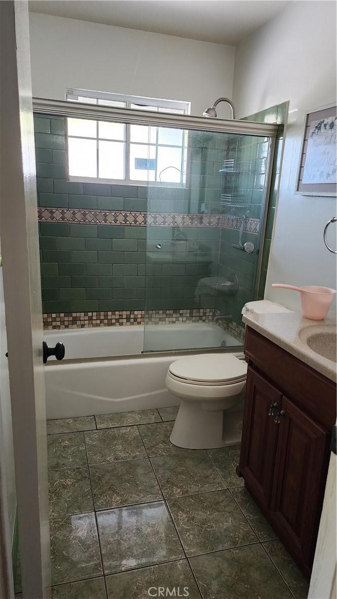 1711 S Washington Ave, Glendora, CA 91740 - full bath featuring toilet, vanity, and combined bath / shower with glass door