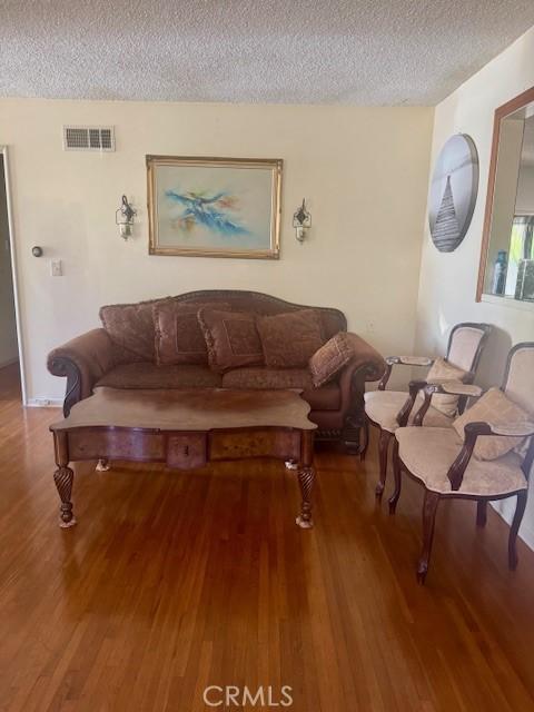 1711 S Washington Ave, Glendora, CA 91740 - living area featuring a textured ceiling and wood finished floors