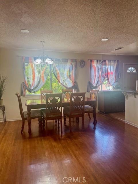 1711 S Washington Ave, Glendora, CA 91740 - dining room featuring a textured ceiling, wood finished floors, a chandelier, and baseboards
