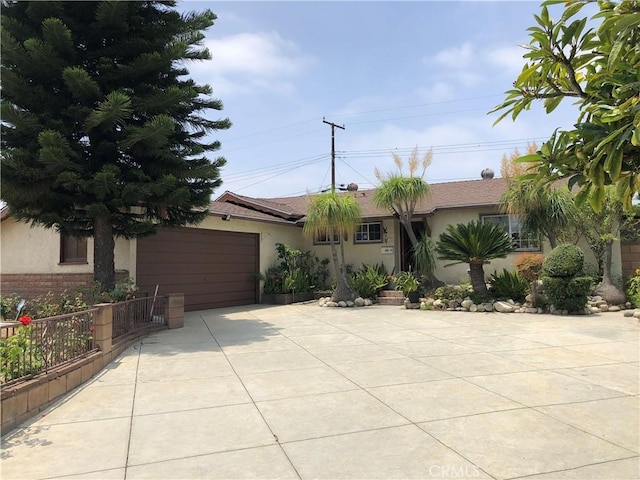 1711 S Washington Ave, Glendora, CA 91740 - ranch-style house with concrete driveway, stucco siding, and an attached garage