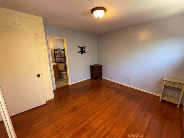 1711 S Washington Ave, Glendora, CA 91740 - unfurnished bedroom featuring wood finished floors, a textured ceiling, and ensuite bathroom
