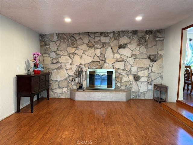 1711 S Washington Ave, Glendora, CA 91740 - unfurnished living room featuring a textured ceiling, a fireplace, and wood finished floors