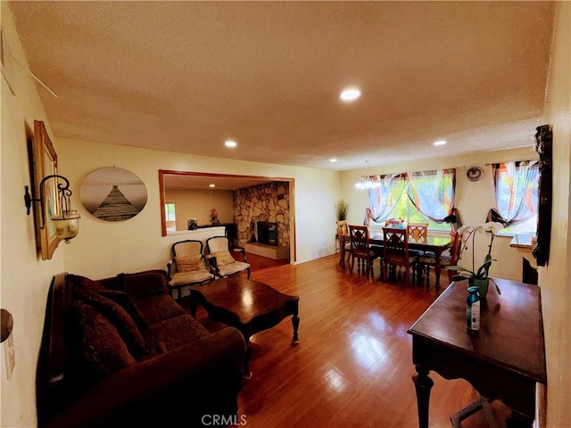 1711 S Washington Ave, Glendora, CA 91740 - living area with wood finished floors, recessed lighting, a textured ceiling, and a fireplace