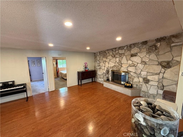 1711 S Washington Ave, Glendora, CA 91740 - living area with a textured ceiling, wood finished floors, a stone fireplace, and recessed lighting