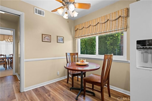 415 S Cedarhaven Way, Anaheim Hills, CA 92807 - dining space with visible vents, baseboards, ceiling fan with notable chandelier, and wood finished floors