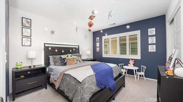 bedroom with visible vents and carpet flooring