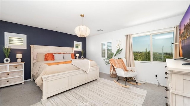 bedroom with baseboards, multiple windows, and light carpet