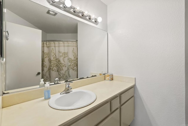 bathroom featuring vanity and a shower with curtain