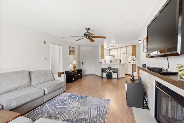 9725 Mesa Springs Way Unit 176, San Diego, CA 92126 - living area with ceiling fan, light wood-type flooring, and a tile fireplace