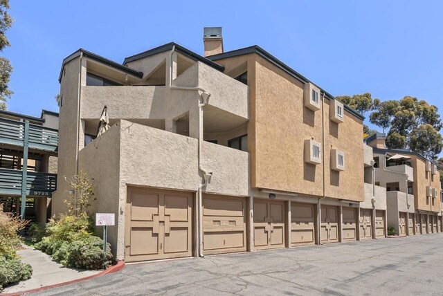 9725 Mesa Springs Way Unit 176, San Diego, CA 92126 - view of property featuring community garages