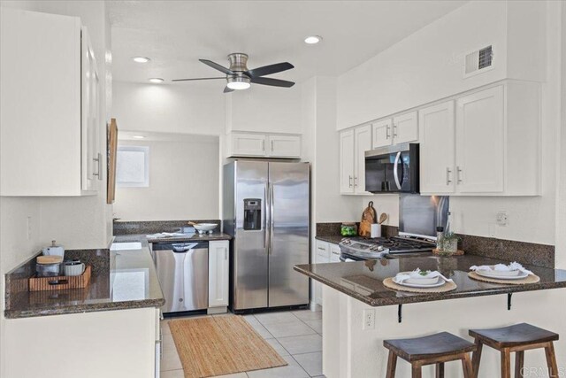 720 San Luis Obispo Pl Unit D, San Diego, CA 92109 - kitchen featuring white cabinets, a peninsula, a ceiling fan, and appliances with stainless steel finishes