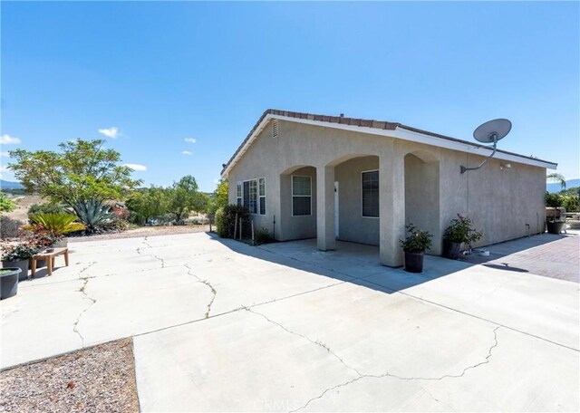 view of front of property with a patio area and stucco siding