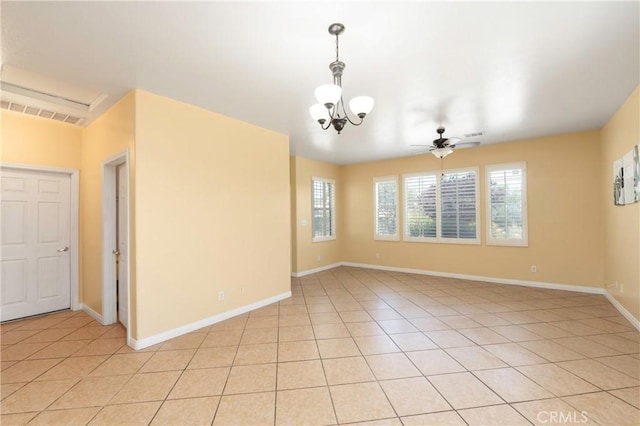 spare room featuring baseboards, visible vents, light tile patterned floors, and ceiling fan with notable chandelier