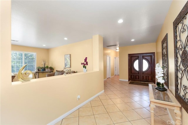 foyer with recessed lighting, baseboards, visible vents, and light tile patterned floors