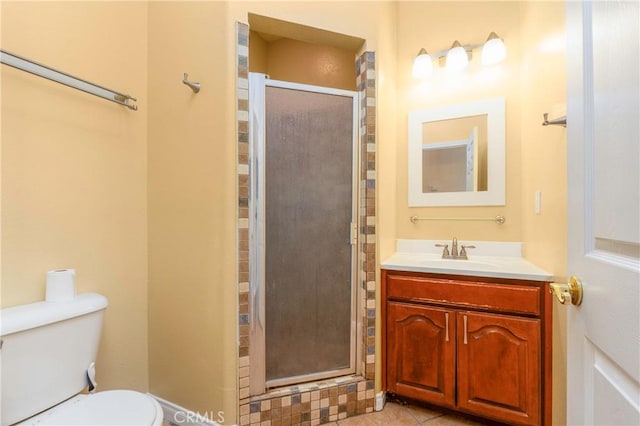 bathroom featuring vanity, tile patterned floors, toilet, and a shower stall