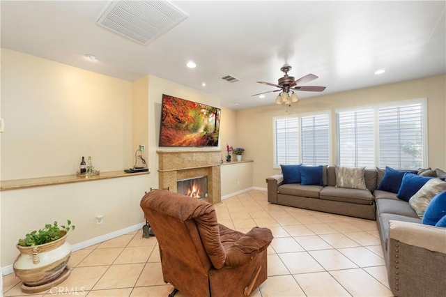 living area featuring visible vents, a ceiling fan, baseboards, and light tile patterned floors