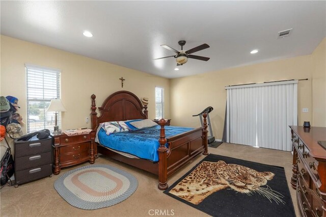 carpeted bedroom with visible vents, recessed lighting, a ceiling fan, and multiple windows