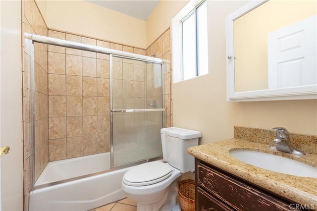 bathroom with toilet, shower / bath combination with glass door, and vanity