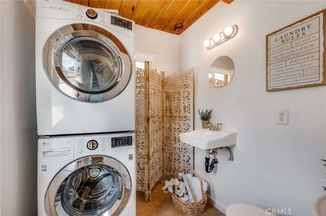 6901 Bertrand Ave, Reseda, CA 91335 - washroom with stacked washing machine and dryer, tile patterned floors, and wooden ceiling