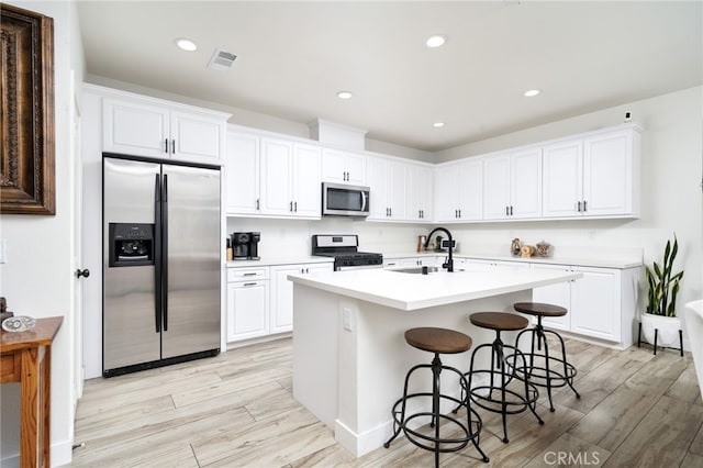 4160 S Bodega Way Unit 2, Ontario, CA 91761 - kitchen featuring stainless steel appliances, a sink, light wood-style floors, white cabinets, and recessed lighting