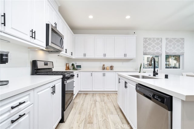 4160 S Bodega Way Unit 2, Ontario, CA 91761 - kitchen featuring appliances with stainless steel finishes, a sink, recessed lighting, light countertops, and white cabinetry