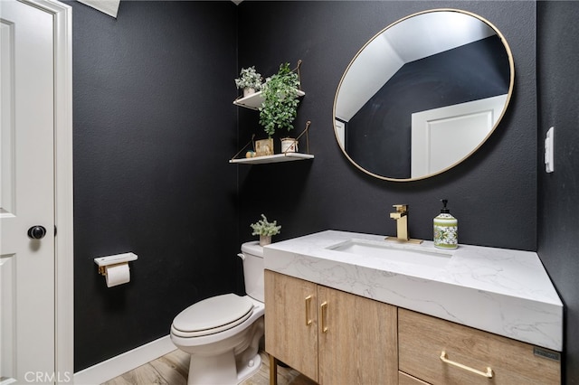 4160 S Bodega Way Unit 2, Ontario, CA 91761 - half bath featuring vanity, toilet, wood finished floors, and baseboards