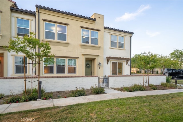 4160 S Bodega Way Unit 2, Ontario, CA 91761 - townhome / multi-family property featuring a gate, a tile roof, stucco siding, and a chimney