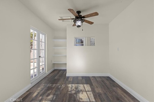 empty room featuring baseboards, a ceiling fan, and wood finished floors