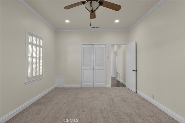 unfurnished bedroom featuring carpet flooring, baseboards, visible vents, recessed lighting, and crown molding