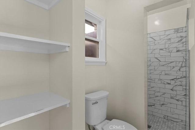 bathroom with a shower stall and toilet