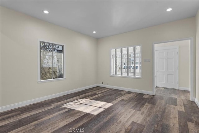 unfurnished room with baseboards, recessed lighting, and dark wood finished floors