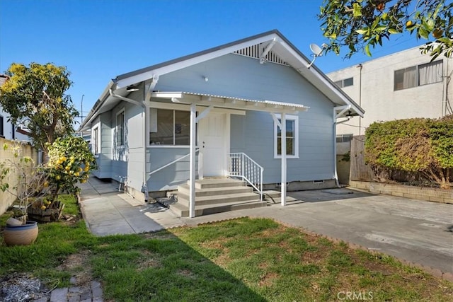 bungalow-style house featuring fence and crawl space