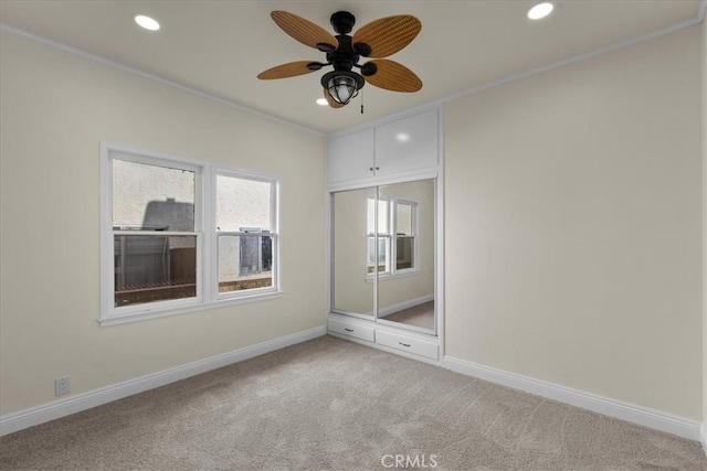 interior space with baseboards, light carpet, a ceiling fan, and recessed lighting