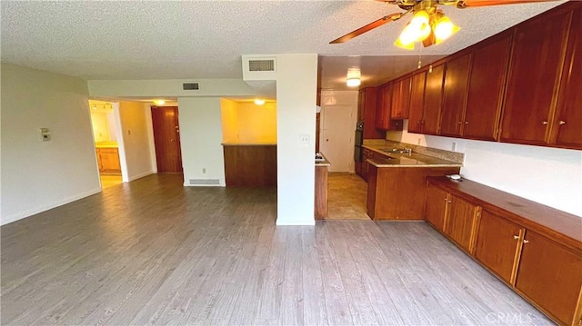 400 S Los Robles Ave Unit 306, Pasadena, CA 91101 - kitchen with a ceiling fan, light wood-style floors, a sink, a textured ceiling, and multiple ovens