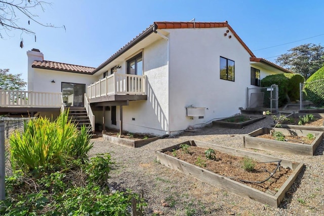 3612 Palomar Dr, Fallbrook, CA 92028 - rear view of house featuring a garden, a tiled roof, a wooden deck, and stucco siding
