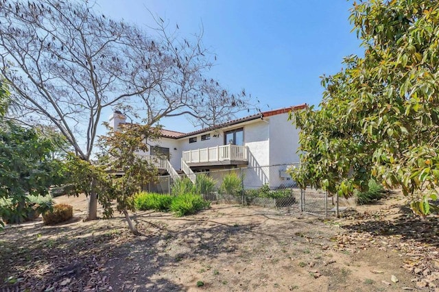 3612 Palomar Dr, Fallbrook, CA 92028 - rear view of house featuring stucco siding, a chimney, and a tile roof