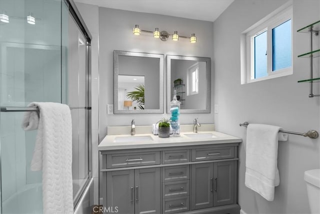 4612 W 161st St, Lawndale, CA 90260 - bathroom featuring double vanity, shower / bath combination with glass door, and toilet