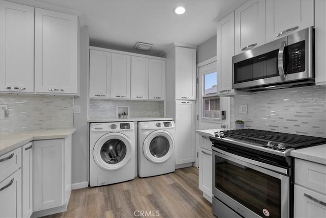 4612 W 161st St, Lawndale, CA 90260 - laundry area with washer and dryer, light wood finished floors, and recessed lighting