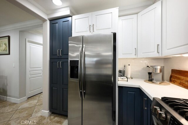 kitchen with blue cabinets, stainless steel appliances, backsplash, light countertops, and ornamental molding