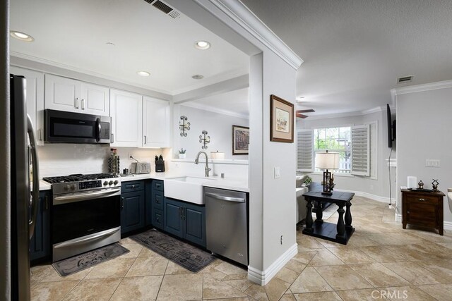 kitchen with ornamental molding, appliances with stainless steel finishes, visible vents, and white cabinets