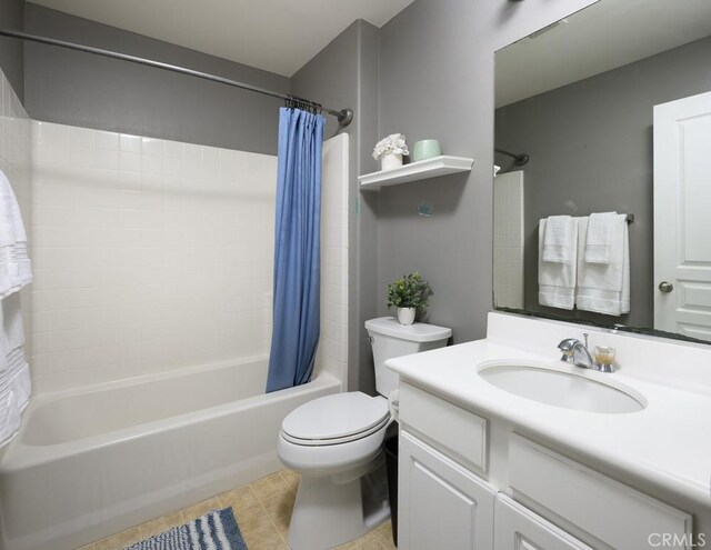 full bathroom with tile patterned flooring, toilet, vanity, and shower / bathtub combination with curtain