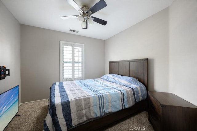 carpeted bedroom with a ceiling fan, visible vents, and baseboards