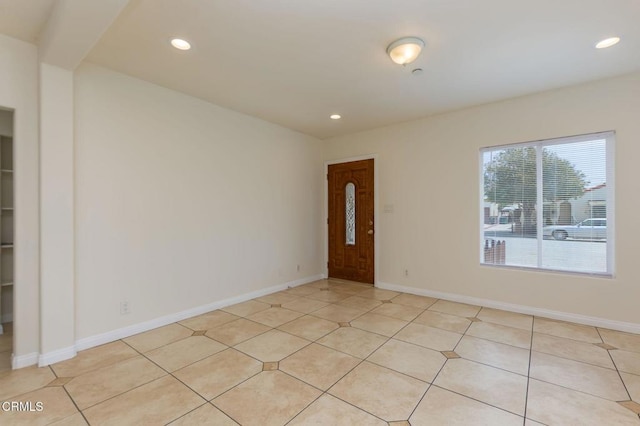 spare room featuring recessed lighting, baseboards, and light tile patterned floors